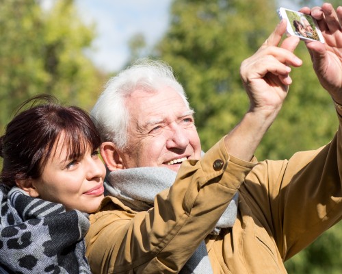 grandfather and granddaughter taking selfie